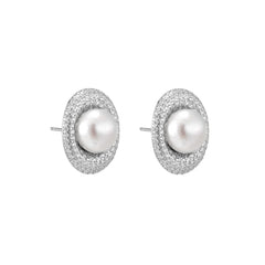 Oval rhodium-plated silver studs featuring freshwater pearls surrounded by pavé crystal halo on white background