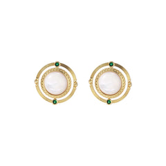 Circular gold stud earrings with iridescent mother-of-pearl center and green zirconia accents on cream background.