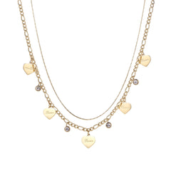 Gold layered necklace set with engraved heart pendants and crystal accents on cream background